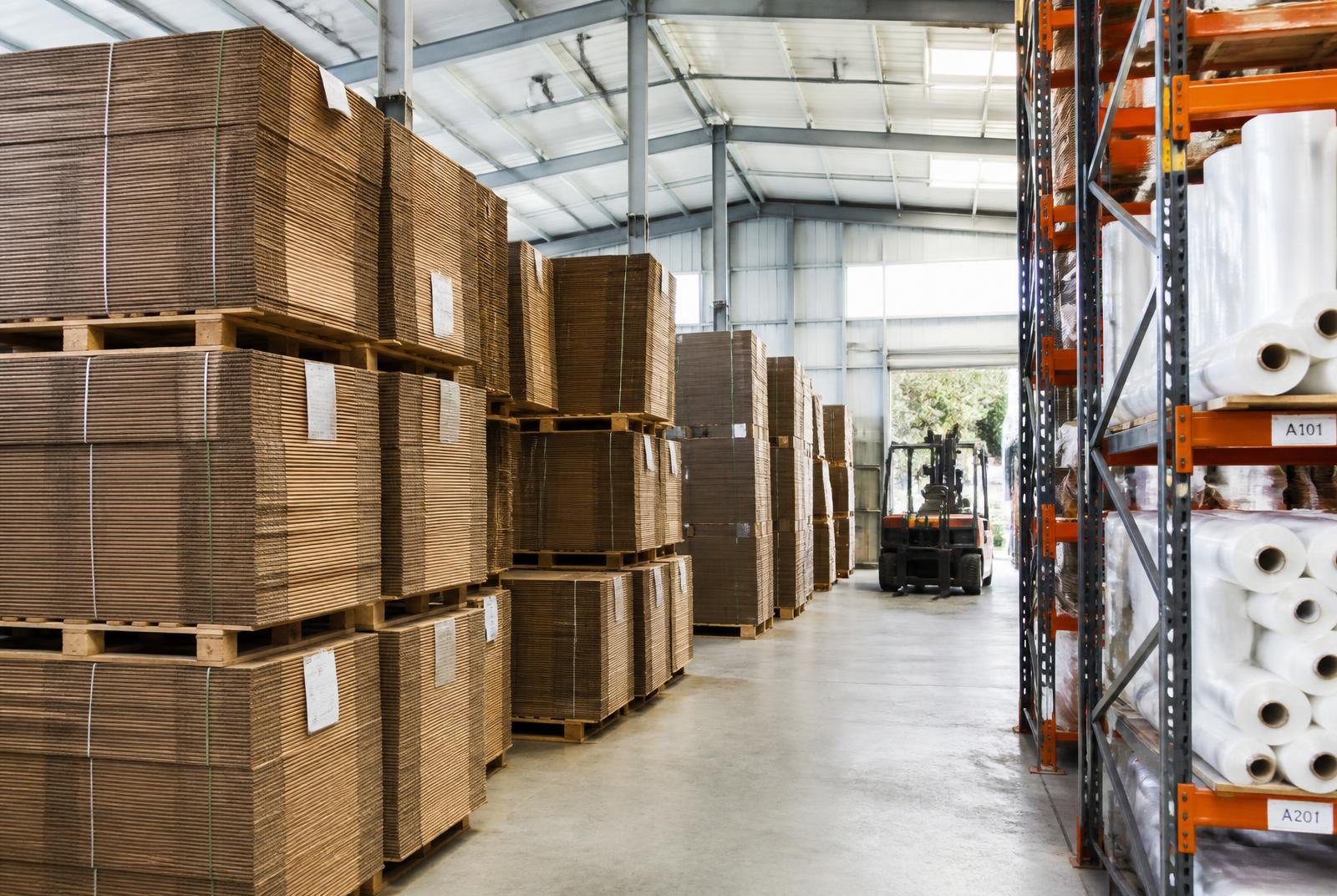 Agribox warehouse with pallets of flat-packed cartons and racking of stretch film rolls